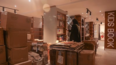 A worker arranges bookshelves ahead of the opening of the new Samir Mansour bookshop that was destroyed during last year's 11-day war between Israel and the Palestinian Hamas movement, in Gaza City.