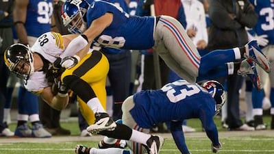 Pittsburgh Steelers' Heath Miller is tackled by Mark Herzlich of the New York Giants.