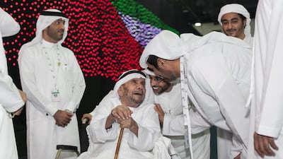 Aqeeda Abdullah Al Muhairi, a 95-year-old natural healer, casts his vote in Al Ain. Mona Al Marzooqi / The National