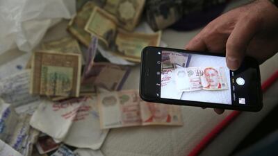 A member of the media uses his mobile phone to take pictures of belongings on a bed inside the flat where a suspect of New Year’s Day nightclub attack was arrested during an overnight police raid, in Istanbul. Lefteris Pitarakis / AP Photo