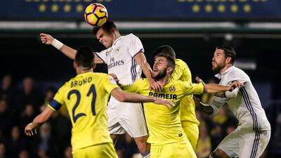 Real Madrid defender Pepe, secondleft, vies with Villareal defender Victor Ruiz. Biel Alino / AFP