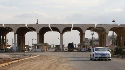 A vehicle steers his way through the recently reopened Nassib border post in the Deraa province,at the Syrian-Jordanian border south of Damascus. AFP