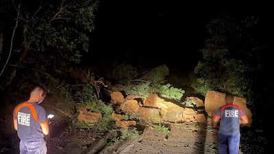 Bureau of Fire Protection members on a road blocked by debris after an earthquake in Ilocos Norte Province, Philippines, October 25, 2022. Reuters