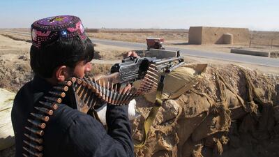 Afghan Local Police personnel keep watch during an ongoing battle with Taliban militants in the Marjah district of Helmand Province on December 23, 2015. Noor Mohammed / AFP Photo