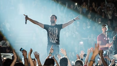 Enrique Iglesias and Anthony Touma perform at Palais Omnisports de Bercy on November 21, 2014 in Paris, France. Patrick / Redferns via Getty Images
