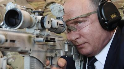 Russian President Vladimir Putin looks through the scope as he shoots a Chukavin sniper rifle during a visit to the military Patriot Park in Kubinka, outside Moscow on September 19, 2018. AFP