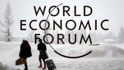 Two people leave the Congress Centre under snow ahead of the opening of the World Economic Forum 2018 annual meeting. Fabrice Coffrini / AFP