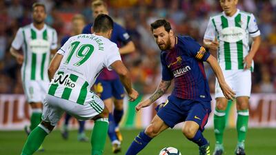 Barcelona forward Lionel Messi, right, dribbles the ball against Real Betis forward Alex Alegria during the Primera Liga match at Camp Nou in Barcelona on August 20, 2017. / Lluis Gene / AFP