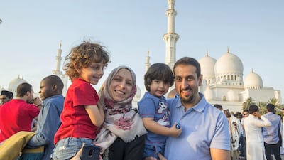Worshippers celebrate Eid Al Fitr outside Sheikh Zayed Mosque early on Tuesday morning.