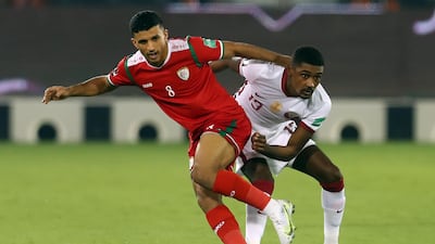 Oman's Abdullah Fawaz, left, in action against Qatar's Mosaab Khidir. The hosts qualified for the AFC Asian Cup 2023 after defeating Oman 1-0 .