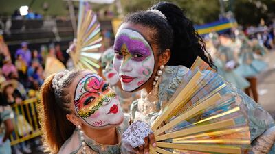 Members of a dance group pose while marching before the Krewe of Zulu. EPA