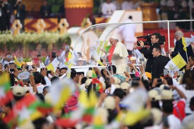 The popemobile transports Pope Francis through Myanmar on the first ever papal visit to the country. AFP