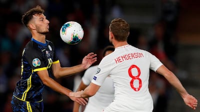 Kosovo defender Leart Paqarada vies with England midfielder Jordan Henderson. AFP