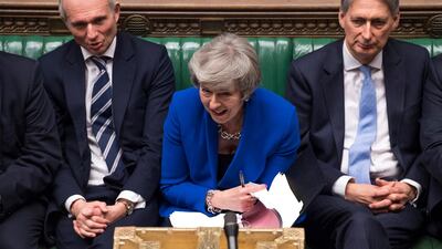 Prime Minister Theresa May reacts during a debate before a no-confidence vote raised by opposition Labour Party leader Jeremy Corbyn, in the House of Commons. AP