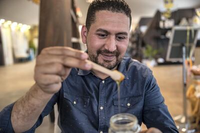 Garden manager Mohamed Ouertani, says natural honey has many health benefits. Photo: Antonie Robertson / The National