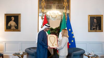 President Sheikh Mohamed presents an Etihad medal to Italian Prime Minister Giorgia Meloni before a meeting at Palazzo Chigi. Photo: Abdulla Al Bedwawi / UAE Presidential Court