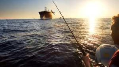 As the sun began to set on the waters in Fujairah, Byron Bower tried to hold onto a fish that was hooked but eventually got away.