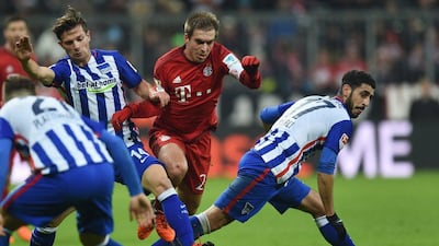 Philipp Lahm, centre, in action for Bayern Munich against Hertha Berlin. Christof Stache / AFP
