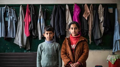 Twins Maha, right, and Mohammad Al Obaid, 11, were born in 2011, the year the Syrian war started. Displaced from Ras Al Ain in north-east Syria three years ago, they are pictured at a school on the outskirts of north-eastern city Hassakeh. All photos: AFP