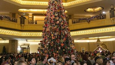 People join a christmas tree lighting at Emirates Palace in Abu Dhabi. Silvia Razgova / The National