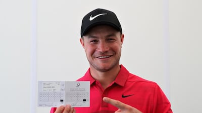 Oliver Fisher celebrates with his scorecard after finishing with a round of 59, the first 59 scored on the European Tour. Getty Images