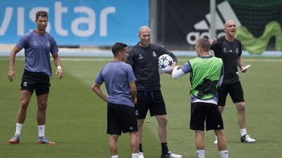 Ronaldo awaits instruction as Zidane speaks with players. Paul White / AP