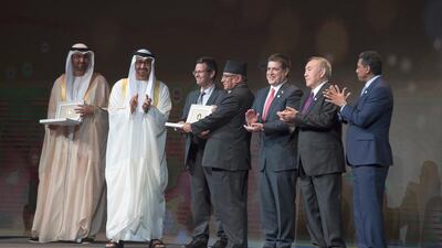 Sheikh Mohammed bin Zayed, Crown Prince of Abu Dhabi and Deputy Supreme Commander of the Armed Forces, and Pushpa Dahal, prime minister of Nepal (4th R), present the Zayed Future Energy Prize in the category of Non-profit Organisation award to Paul Smith Lomas, chief executive of Practical Action (5th R), during the World Future Energy Summit, part of Abu Dhabi Sustainability Week, at Abu Dhabi National Exhibition Centre. Also present were Danny Faure, president of the Seychelles (R), Nursultan Nazarbayev, president of Kazakhstan (2nd R), Horacio Cartes, president of Paraguay (3rd R) and Dr Sultan Al Jaber, Minister of State, Chairman of Masdar and Chief Executive of the Adnoc Group. Hamad Al Kaabi / Crown Prince Court — Abu Dhabi