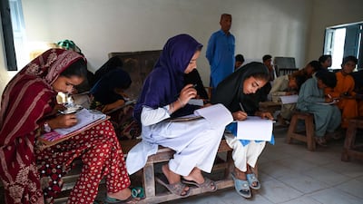 Students sit for an exam in their classroom during a power cut at a government school in Jacobabad, in southern Sindh province in May last year. AFP