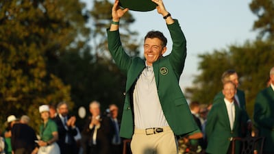 Rory McIlroy of Northern Ireland holds up the trophy while wearing the Green Jacket after winning the 2026 Masters in Augusta, Georgia. EPA