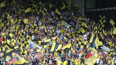Watford supporters wave flags and cheer on their club on Saturday at Vicarage Road during the team's Premier League contest against West Brom. Matthew Childs / Action Images / Reuters