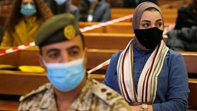 A Jordanian muslim woman and a soldier wearing protective masks and maintaining social distance attend a mass before the Christmas tree lighting ceremony, at Church of the Sacred Heart, amid fears over rising numbers of coronavirus disease cases in downtown Amman, Jordan. Reuters
