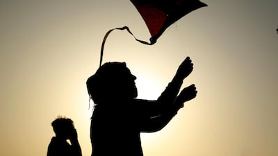 Kite flyers at the Baghdad Kite Festival are silhouetted as the sun sets in the Iraqi capital. AP Photo