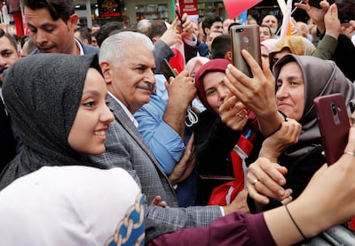Binali Yildirim, Istanbul mayoral candidate of the ruling AK Party, poses for a selfie with supporters at a campaign rally on June 21, 2019. Reuters