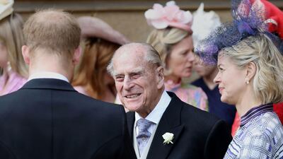 Prince Philip, Duke of Edinburgh, chats to Prince Harry, Duke of Sussex, as they the chapel. AFP