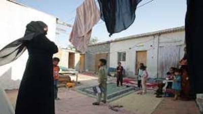 Children stay at home in their compound in Dubai because their parents cannot afford to send them to school.