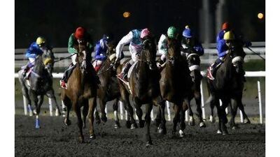 Tom Queally, in the pink helmet, rides Twice Over to victory in the Al Maktoum Challenge Round three at Meydan Racecourse on Thursday night.