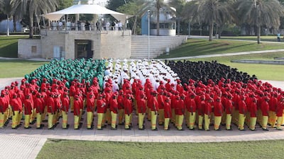 Dubai Municipality horticulture workers create form up to create a large, ‘living’ UAE flag at Zabeel Park. Pawan Singh / The National