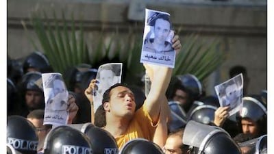 Egyptians shout anti-police slogans and hold up posters of 28-year-old Khaled Said during the trial session of two Egyptian policemen charged with brutality in the death of the young Alexandria man. Tarek Fawzy / AP Photo