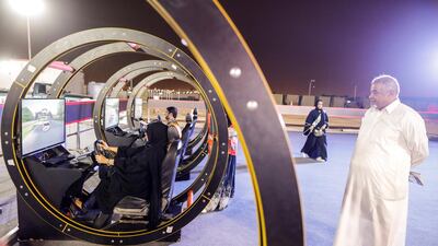 Badour Sami Bakri, 35, a public administration lecturer, attends a driving awareness campaign as her father stands watch in Jeddah, Saudi Arabia June 21, 2018. Picture taken June 21, 2018. REUTERS/Zohra Bensemra