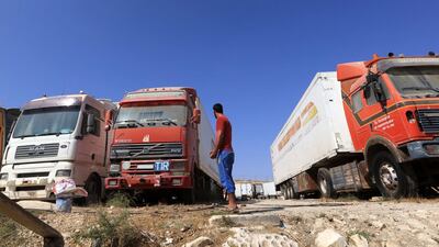 A man waits near trucks parked near Jaber-Nassib border crossing between Syria and Jordan. EPA