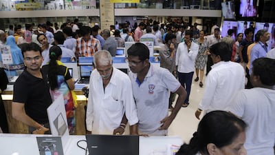 Customers crowd an electronics shop in Mumbai, India on Friday, June 30, 2017, a day before the implementation of the nationwide Goods and Services Tax (GST). The single, nationwide tax starting on July 1 replaces a complicated mix of state and federal taxes and will change the cost of nearly everything people buy. Rajanish Kakade / AP