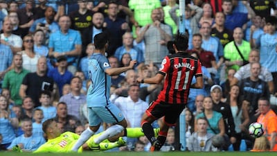 Manchester City’s Ilkay Gundogan, centre, scores the fourth goal against Bournemouth. Peter Powell / EPA