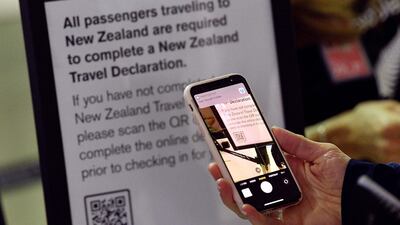 A passenger scans a barcode to complete travel declarations for New Zealand flights at Sydney International Airport. AFP