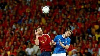 Spain's Xabi Alonso, left, and Italy's Claudio Marchisio go for a header. KERIM OKTEN / EPA
