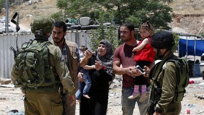 A Palestinian family argues with Israeli soldiers at a checkpoint in Yatta on June 9, 2016, after the military announced that it would not allow any Palestinians to leave or enter the West Bank town. Abed Al Hashlamoun/EPA