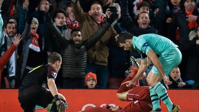 Liverpool's Mohamed Salah is brought down in the area by Arsenal defender Sokratis Papastathopoulos, right, at Anfield on Saturday. EPA