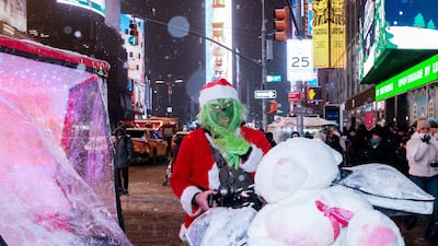 A pedicab driver dressed as the Grinch in Times Square. Reuters