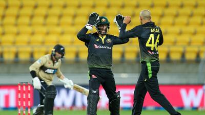 Australia's Matthew Wade and Ashton Agar celebrate the wicket of Devon Conway. Getty