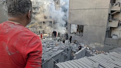 A man looks on as rescuers sift through the rubble of a levelled building in Basta. AFP