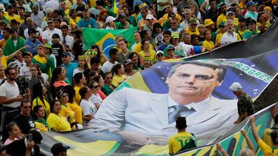 Supporters display a giant banner with the likeness of Brazil's new President Jair Bolsonaro,. AP